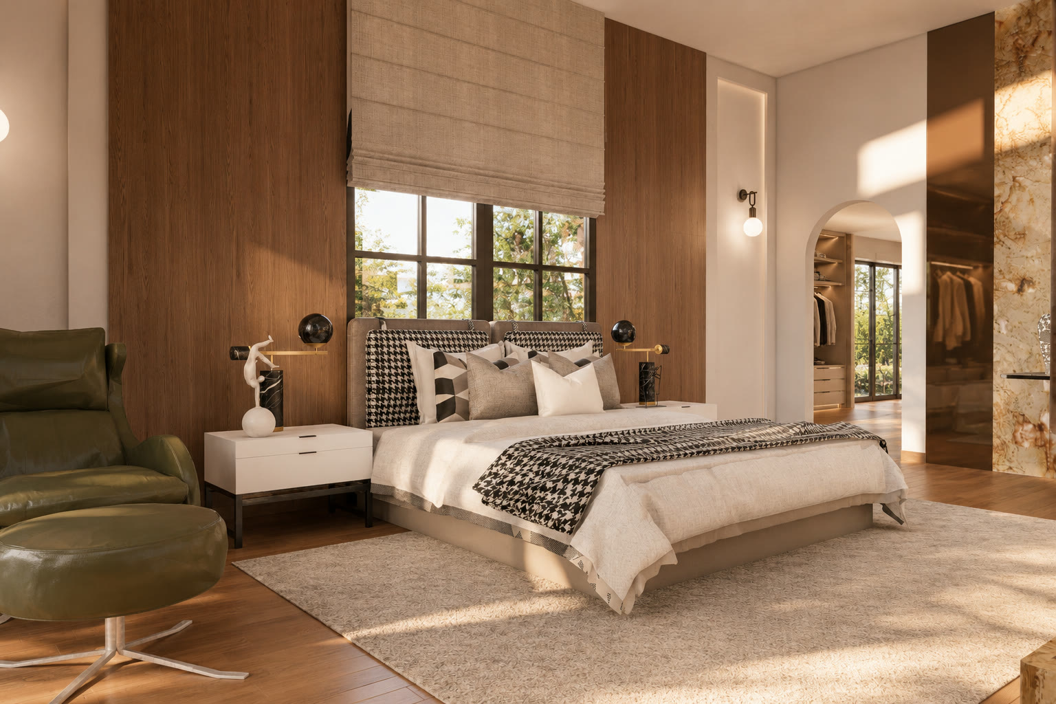 The bed against a walnut-panelled wall under a linen blind, an olive lounge chair in the foreground and an arch opening onto the walk-in wardrobe