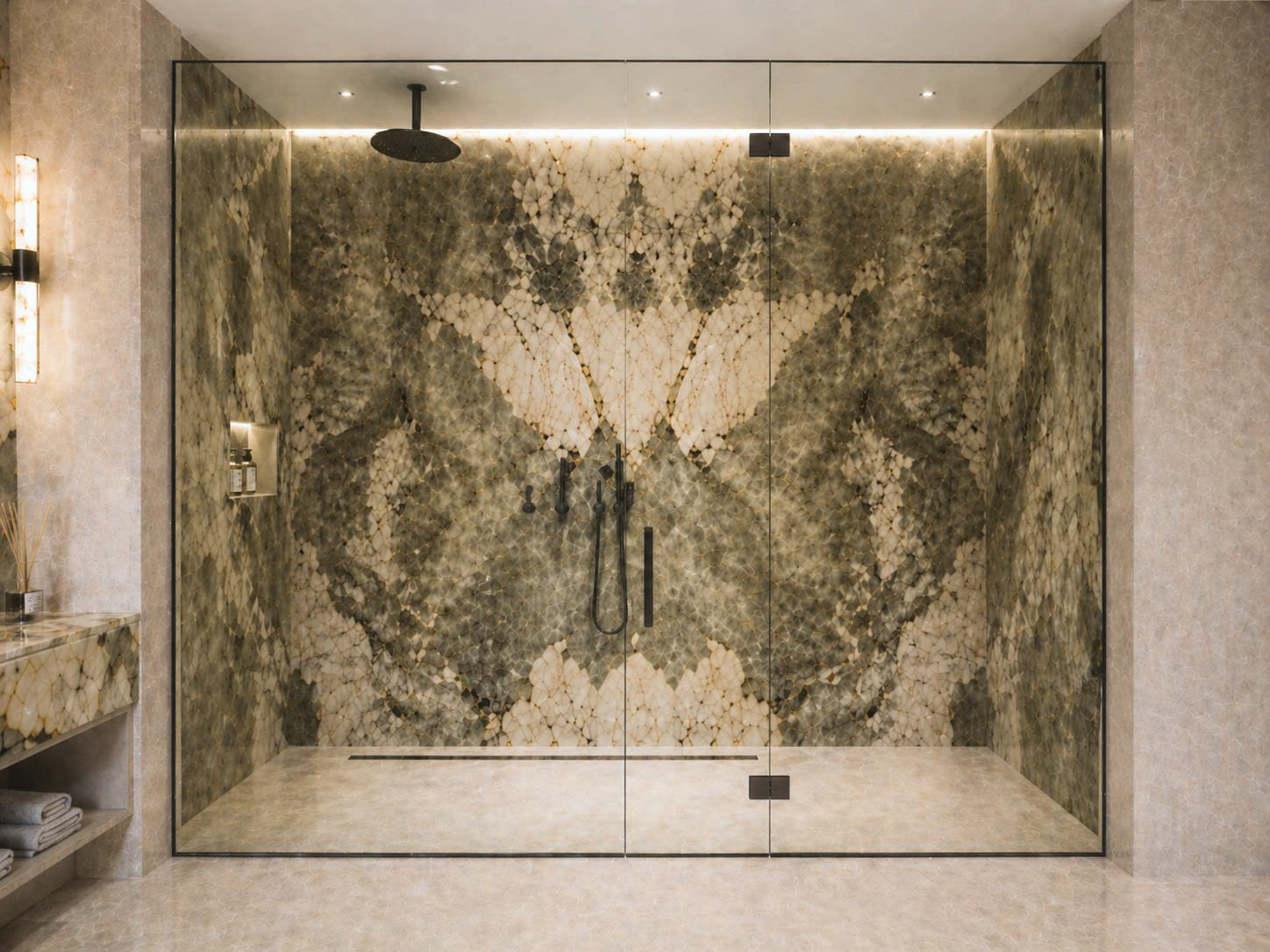 The shower, its walls in bookmatched Patagonia slabs behind frameless glass, with matte black fittings